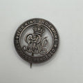 Silver badge with text 'For King and Empire' on a light gray background