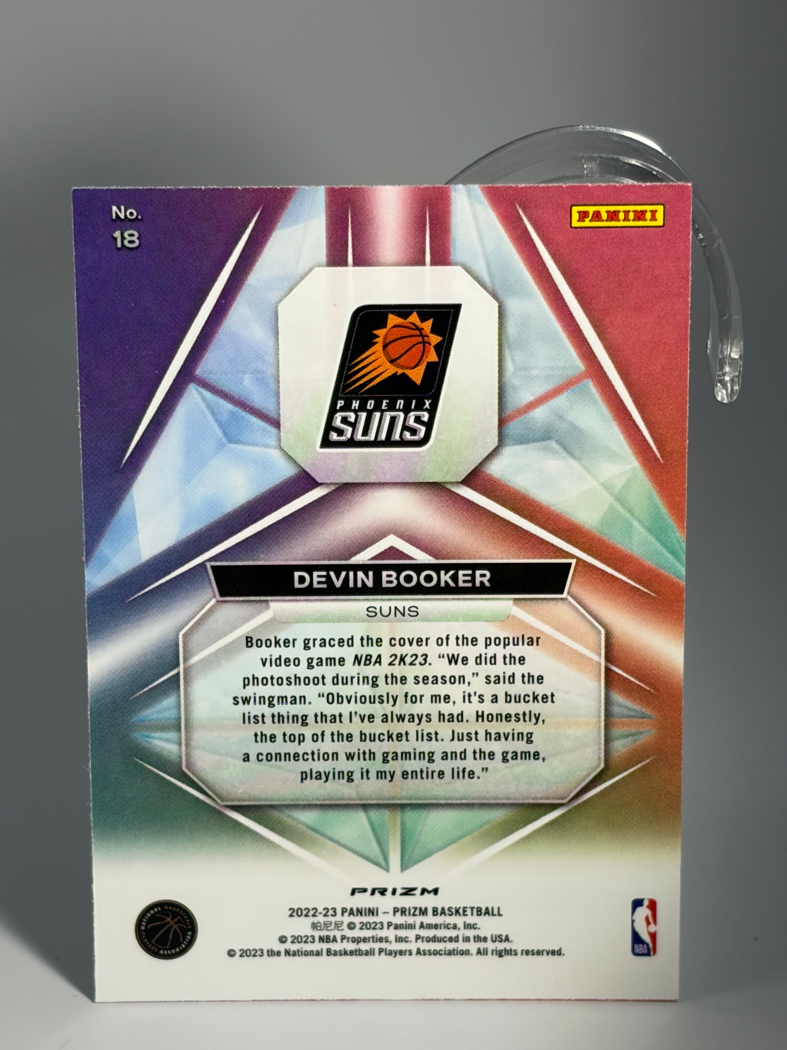 Basketball trading card with player's name and team logo on a gray background