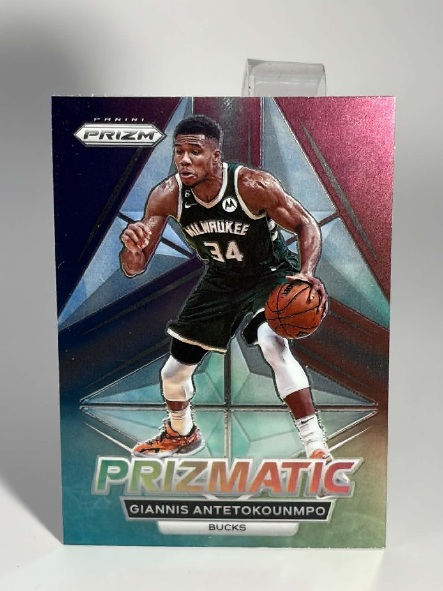 Basketball trading card featuring a player in a black jersey with the number 34, held by a Prizm brand.