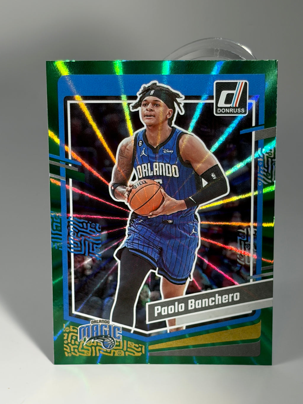 Basketball trading card of a player in action with colorful background