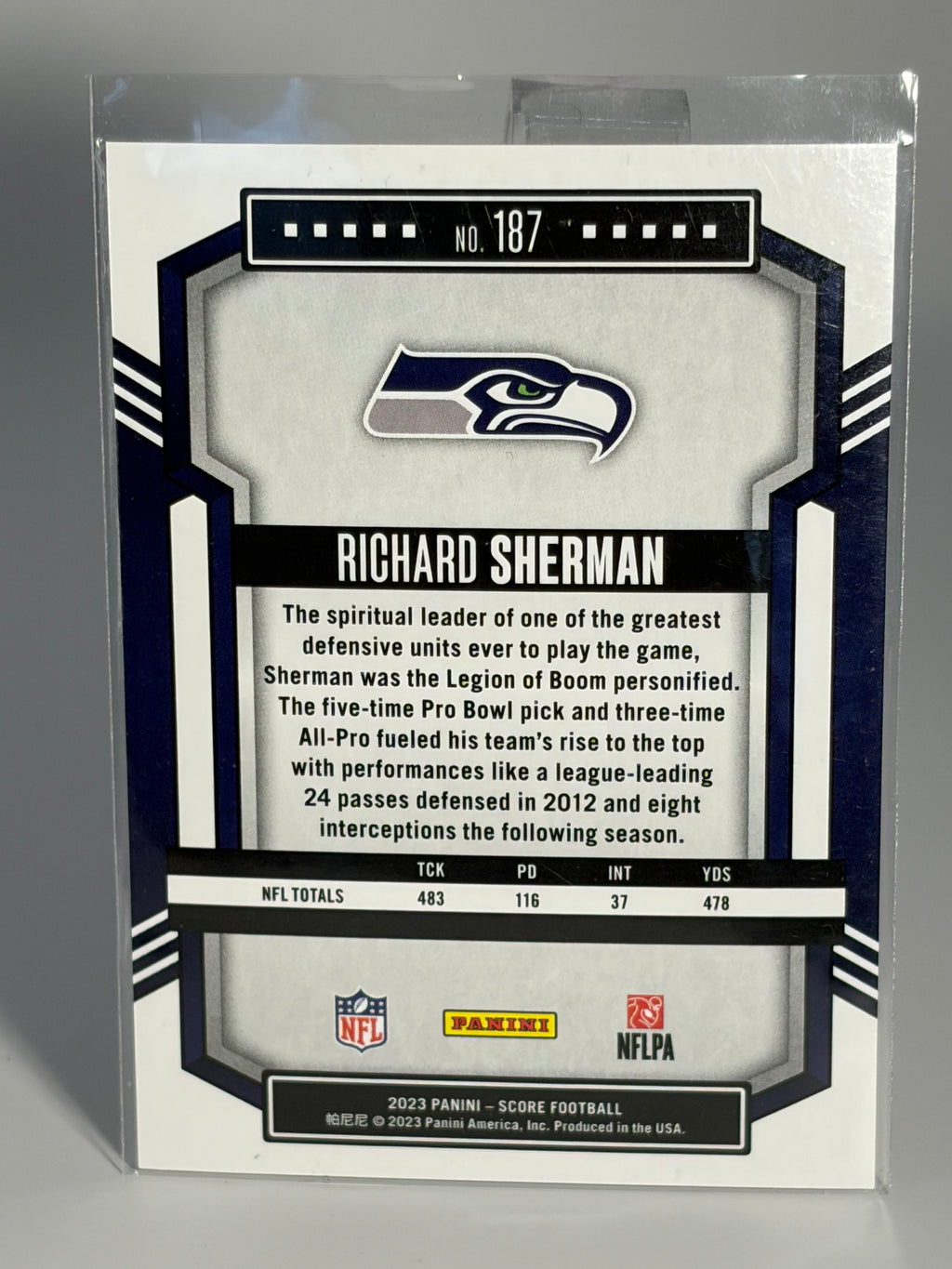 Richard Sherman sports trading card with Seahawks logo and player information on a reflective surface