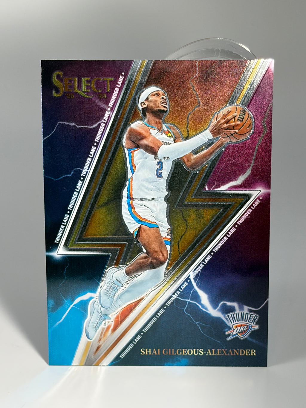 Basketball trading card of a player in action on a colorful background