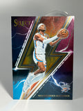 Basketball trading card of a player in action on a colorful background